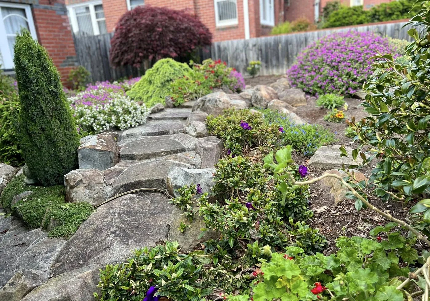Stone garden path surrounded by flowering plants