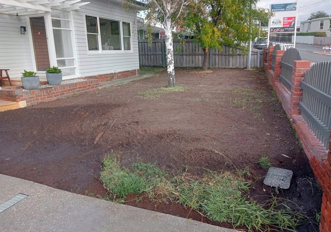 Bare front yard before landscaping and concrete work